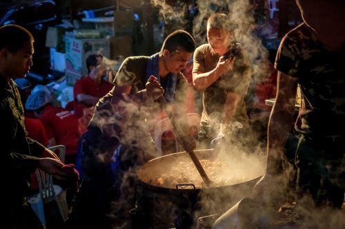 Military personnel cook dinner for rescuers at the makeshift camp at Khun Nam Nang Non Forest Park. Picture: Getty