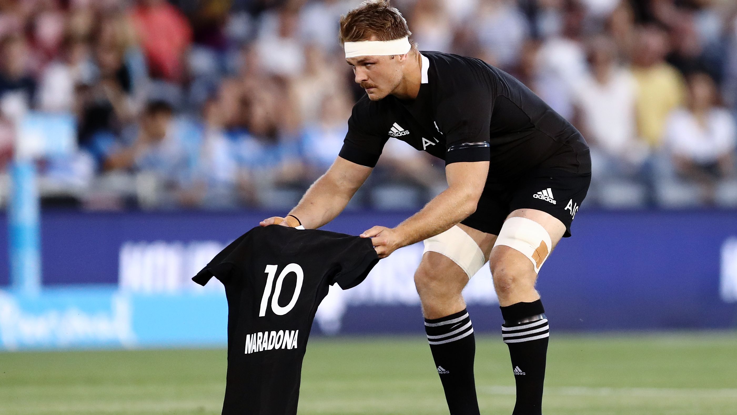 Sam Cane of the All Blacks lays down a number 10 jersey in memory of Diego Maradona.