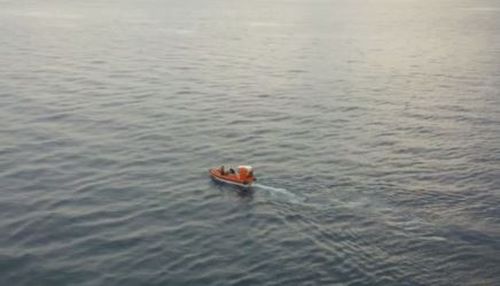 A person on the Sun Princess tweeted a picture of a small rescue boat speeding away from the cruiseliner. (Supplied)