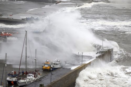 Waves crash over the harbour on October 19, 2023 in Stonehaven, Scotland. 