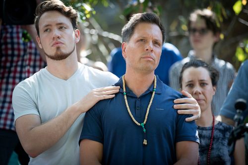 Don Damond is comforted by his son Zach Damond before making a statement to the press near his home after Minneapolis police officer shot and killed his fiancee Justine. (Star Tribune via AP)