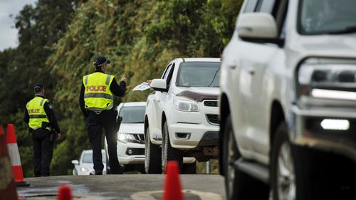 Commuters are stopped by police at the Queensland - NSW border checkpoint in the Gold Coast hinterland at Nerang Murwillumbah Road, near Natural bridge.