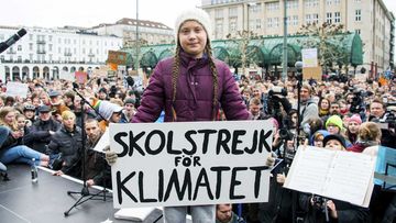 Greta Thunberg holds a sign reading 'School Strike For The Climate' at a rally in Hamburg, Germany.