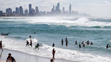 People swim at Burleigh Heads beach in Gold Coast, Australia, after coronavirus restrictions were lifted.