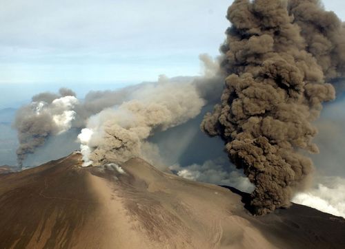 Smoke pours from the summit of Mount Etna in Sicily.