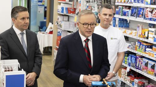 Minister for Health and Aged Care Mark Butler, Prime Minister Anthony Albanese and Trent Twomey, National President, Pharmacy Guild of Australia, at a doorstop interview during a visit to Capital Chemist in Kingston, ACT, on Wednesday 7 September 2022. fedpol Photo: Alex Ellinghausen