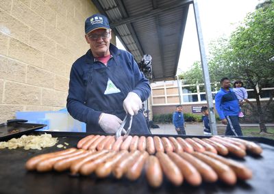 Peter Sullivan cooks sausages at Albany Rise Primary School in Mulgrave in Melbourne.