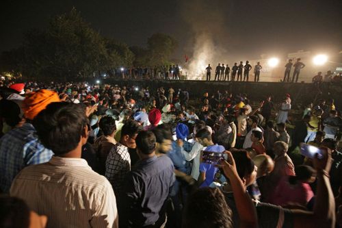 A speeding train has ran over a crowd watching fireworks during a religious festival in northern India, killing at least 58 people and injuring dozens more, police said.