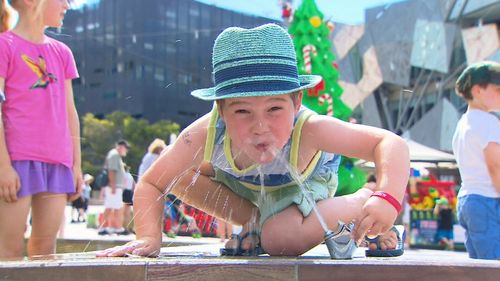 A youngster takes a drink as the West heats up today.