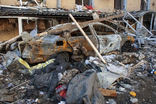 A car destroyed by shelling is seen in a street in Kharkiv, Ukraine, Tuesday, March 22, 2022. (AP Photo/Andrew Marienko)