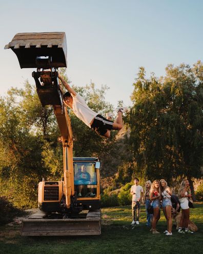 Partygoers were seen 'swinging' from heavy machinery at points during the party.