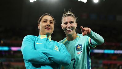 Sam Kerr and Steph Catley applaud fans after the Matildas' 4-0 victory and qualification for the knockout stage of the FIFA Women's World Cup on July 31, 2023 in Melbourne, Australia. 