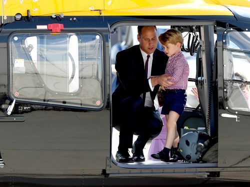 Prince George explores a helicopter with his father during a royal tour of Poland and Germany this month. (AAP)