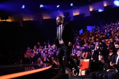 Justin Kurzel walks on stage to accept the AACTA Award for Best Direction in Film at the 2021 AACTA Awards