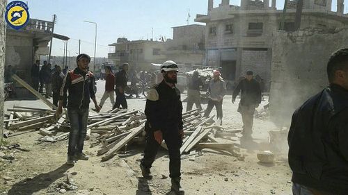 A photo of  Civil Defense workers and Syrian citizens inspecting damaged buildings after airstrikes hit Maarat al-Nuaman supplied by the Syrian Civil Defense group, the White Helmets. (AAP)