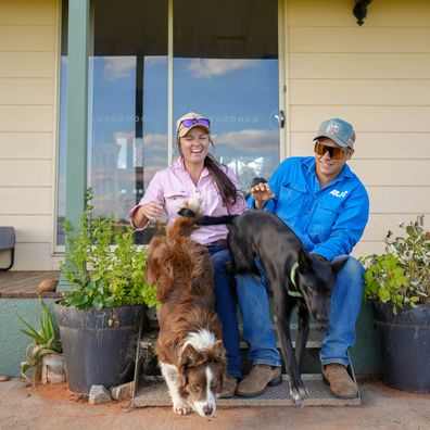Lauren and Nick Jackson at their outback home with two of their dogs.