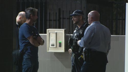 A man with an axe has surrendered to police after an incident in the car park of the Crime and Corruption Commission headquarters building in Brisbane.