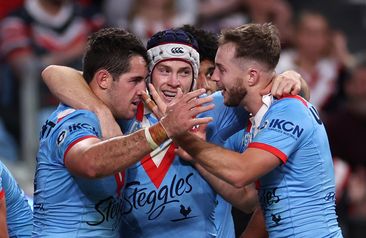 Nat Butcher of the Roosters celebrates scoring a try with teammates Luke Keary and Sam Walker.