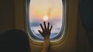 Boy looking outside from the window of airplane.