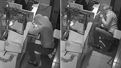 The man can be seen sneaking up to the cash register before peaking into drawers. (Victoria Police)