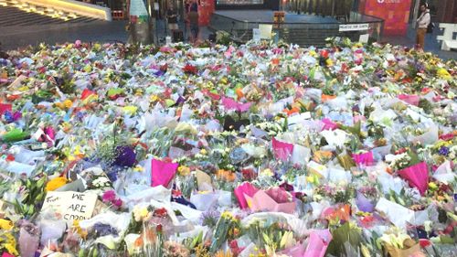 The victims of the siege have been remembered with a growing floral tribute at Martin Place.
