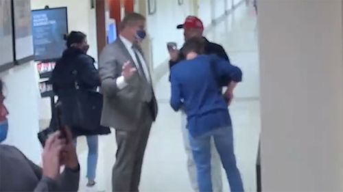 As Barry Loudermilk showed a group around the Capitol, a man involved in the protest is seen taking a photo of a stairwell.