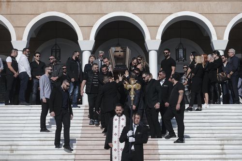 The coffin of slain Greek Australian John Macris is carried out of an Orthodox church after his funeral ceremony south of Athens (AP Photo/Yorgos Karahal)