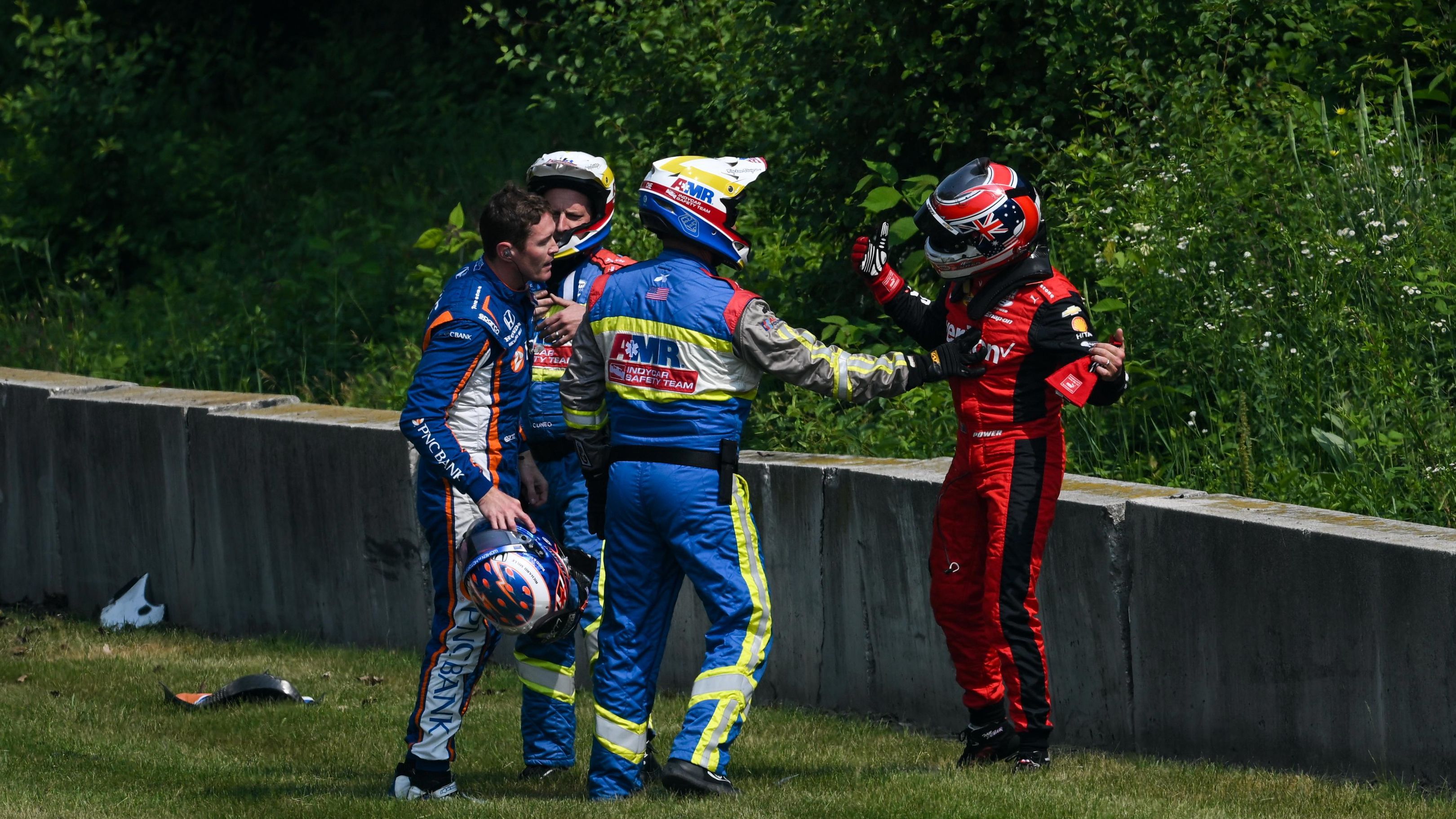 Will Power (right) confronts Scott Dixon after crashing in practice.