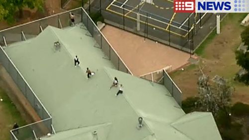 Authorities are trying to convince the inmates to come down. (9NEWS)