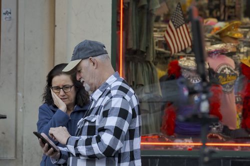 People react at the intersection of Bourbon Street and Canal Street 