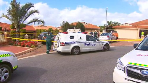 Police investigate the scene at a driveway in Woodvale where two men were allegedly murdered. (9NEWS)
