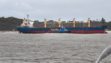 Portland Bay is guided by tugs as it sails into Botany Bay, Sydney.