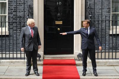 French and UK leaders greet each other under COVID-safe precautions