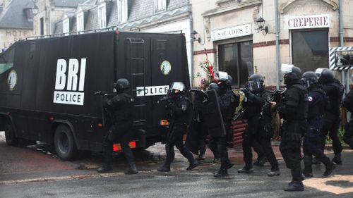 Heavily-armed French police patrol in Longpont, north of Paris during the hunt for the Charlie Hedbo gunmen, (AAP)