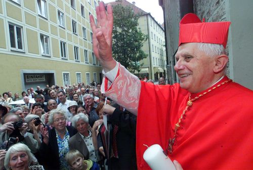 The Vatican's Prefect for the Doctrine of the Faith, Cardinal Joseph Ratzinger, waves to faithful following a mass on the occasion of the 50th anniversary of his priest ordination in the cathedral of Munich, southern Germany, on July 8, 2001. 
