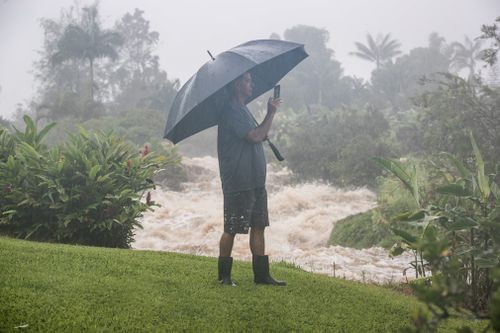 A resident watches the floodwaters.