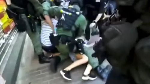 Hong Kong police have come under fire after footage of officers tackling a 12-year-old girl to the ground near a pro-democracy protest went viral.