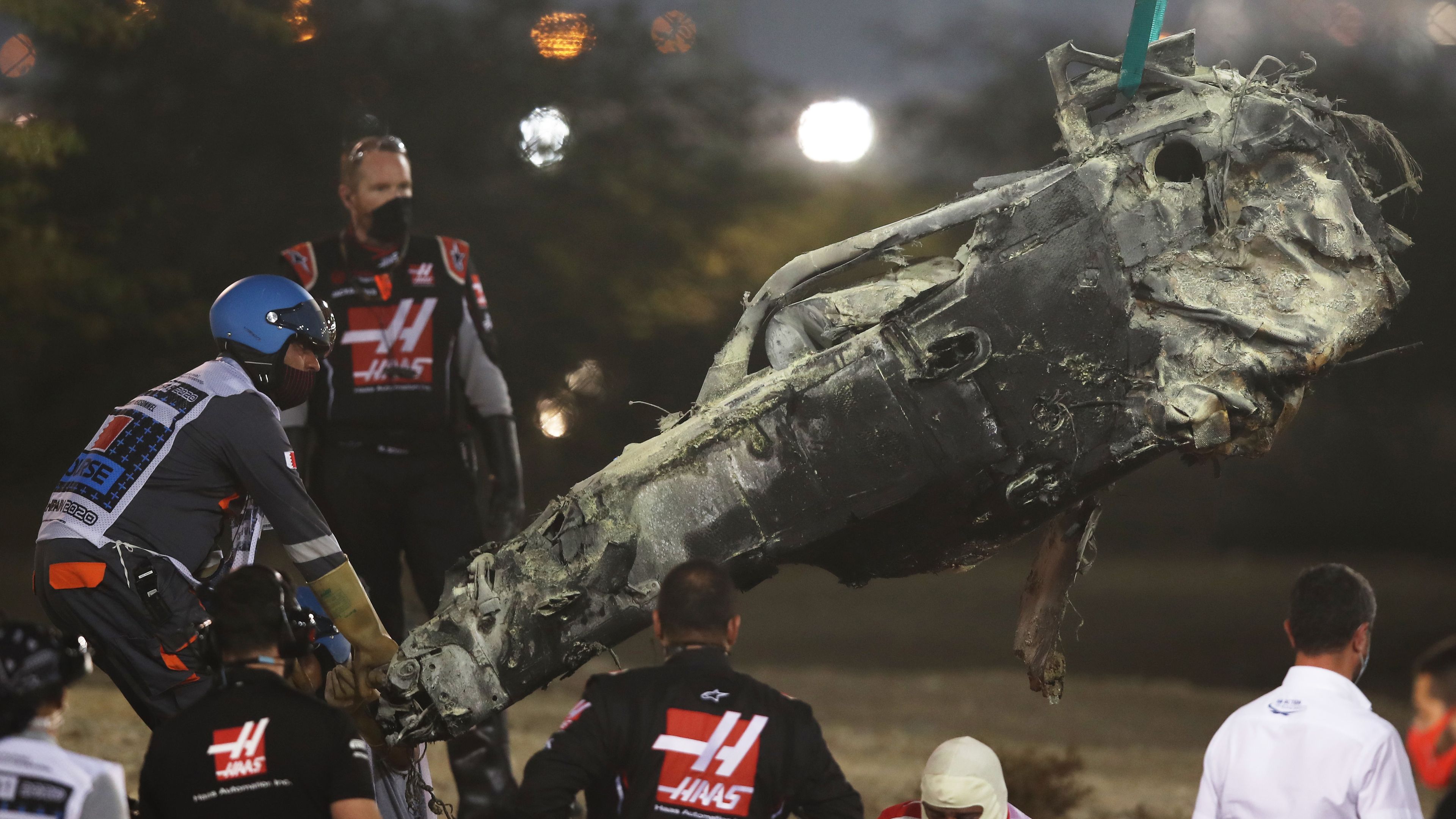 Track marshals clear the debris following Romain Grosjean&#x27;s crash at the Bahrain GP.