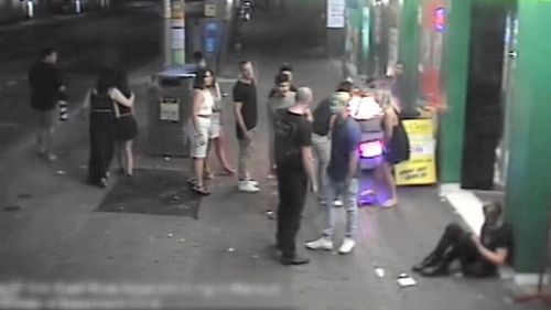 CCTV shows two men talking in the street. (9NEWS)