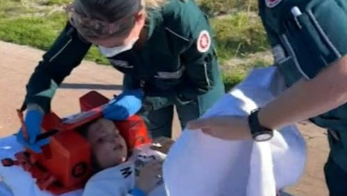 Paramedics treat a little girl hit in an e-scooter crash