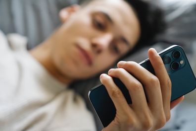 Man in bed on phone