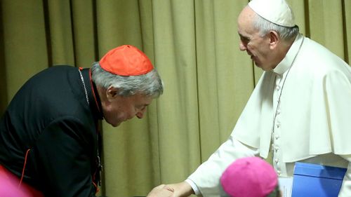 Pope Francis greets Australian Cardinal George Pell as he arrives at the Synod Hall in the Vatican. (Getty Images)