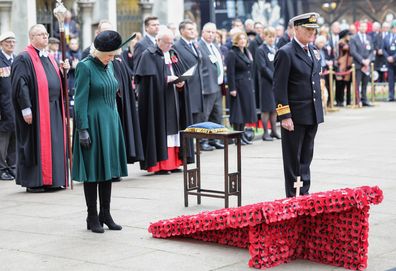 Camilla, Queen Consort bows her head as a mark of respect as she attends the 94th Year of The Field Of Remembrance at Westminster Abbey on November 10, 2022 in London