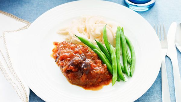 Lamb leg steak with tomato and olives