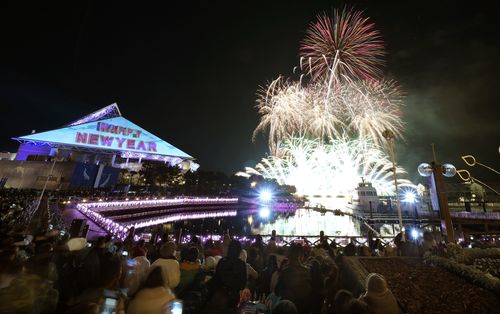 Visitors watch the fireworks display during a New Year celebration event at the Hakkeijima Sea Paradise aquarium-amusement park complex in Yokohama, southwest of Tokyo. (AAP)