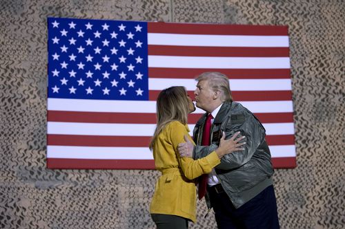 The Trumps exchange a kiss at the airbase in Iraq.