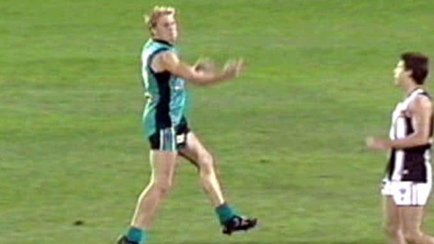 Kane Cornes flips his middle finger at Brodie Holland after the siren