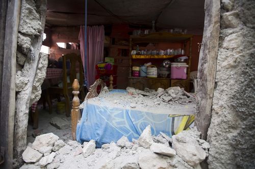 A bed is covered in rubble caused by a magnitude 5.9 earthquake the night before, in Gros Morne, Haiti