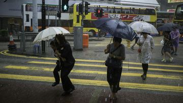 Hong Kong is battered by rain as it prepares for Typhoon Haima. (AFP)