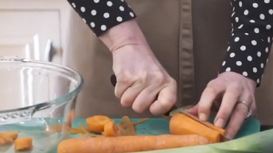 The Duchess of Cambridge chopping carrots for the vegetable soup.